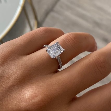Woman's hand wearing a large square diamond engagement ring