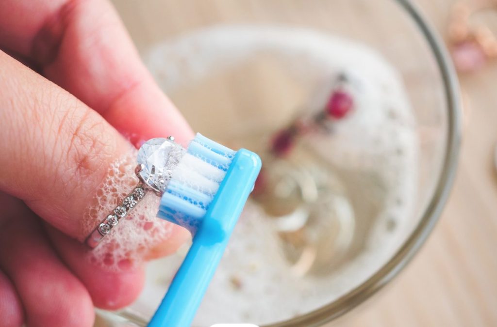 Engagement ring being cleaned with a toothbrush