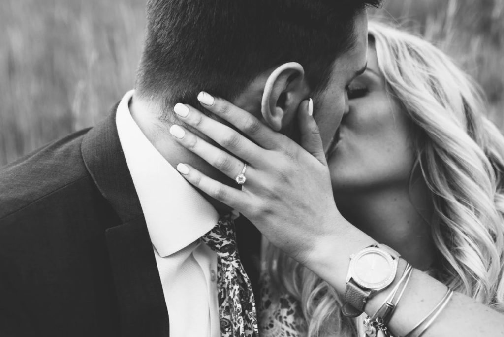 Engaged couple kissing