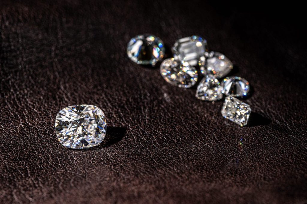 Group of diamonds on a wooden surface.